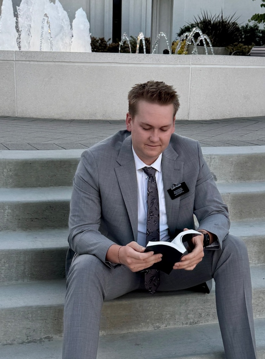 Michael reading his scriptures on the temple steps