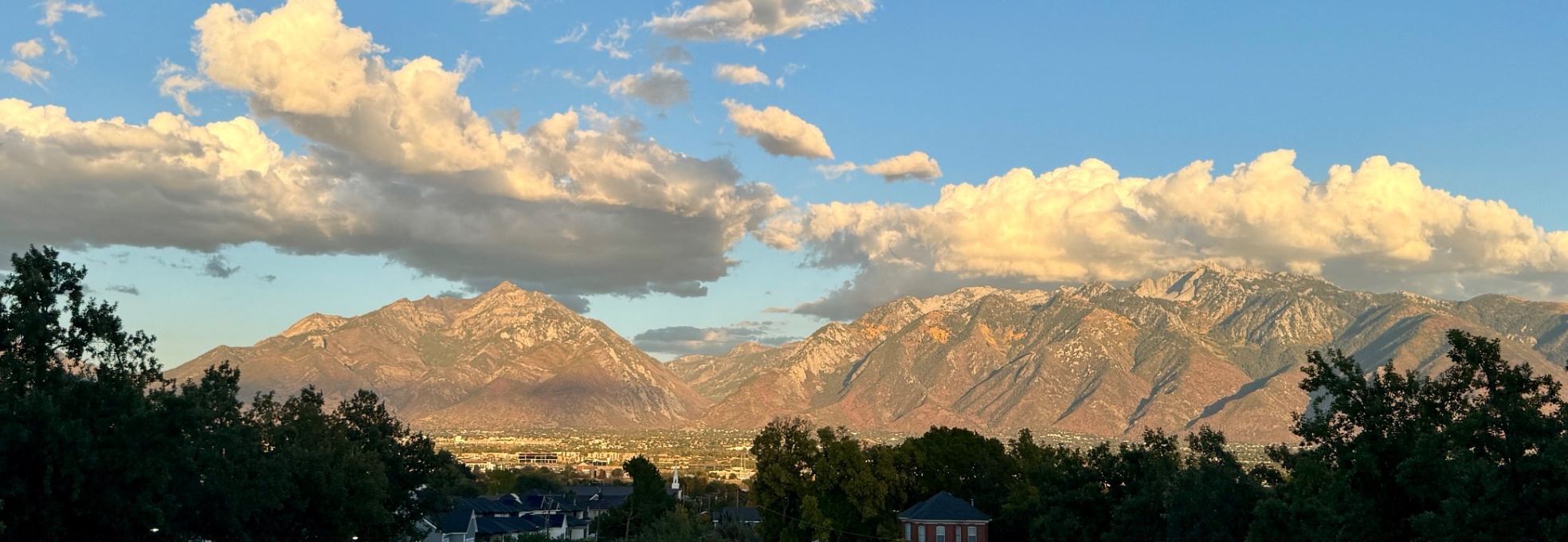 Sunlit mountains and clouds viewed from the temple grounds